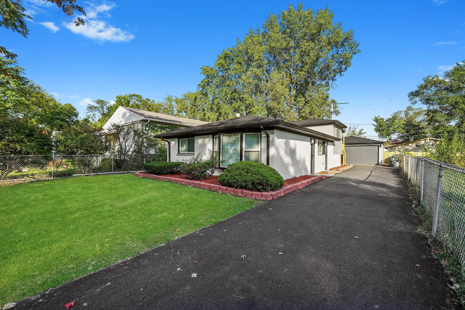 16619 Marshfield Avenue Markham, IL 60428 - Photo 2 of 41 a front view of a house with a yard