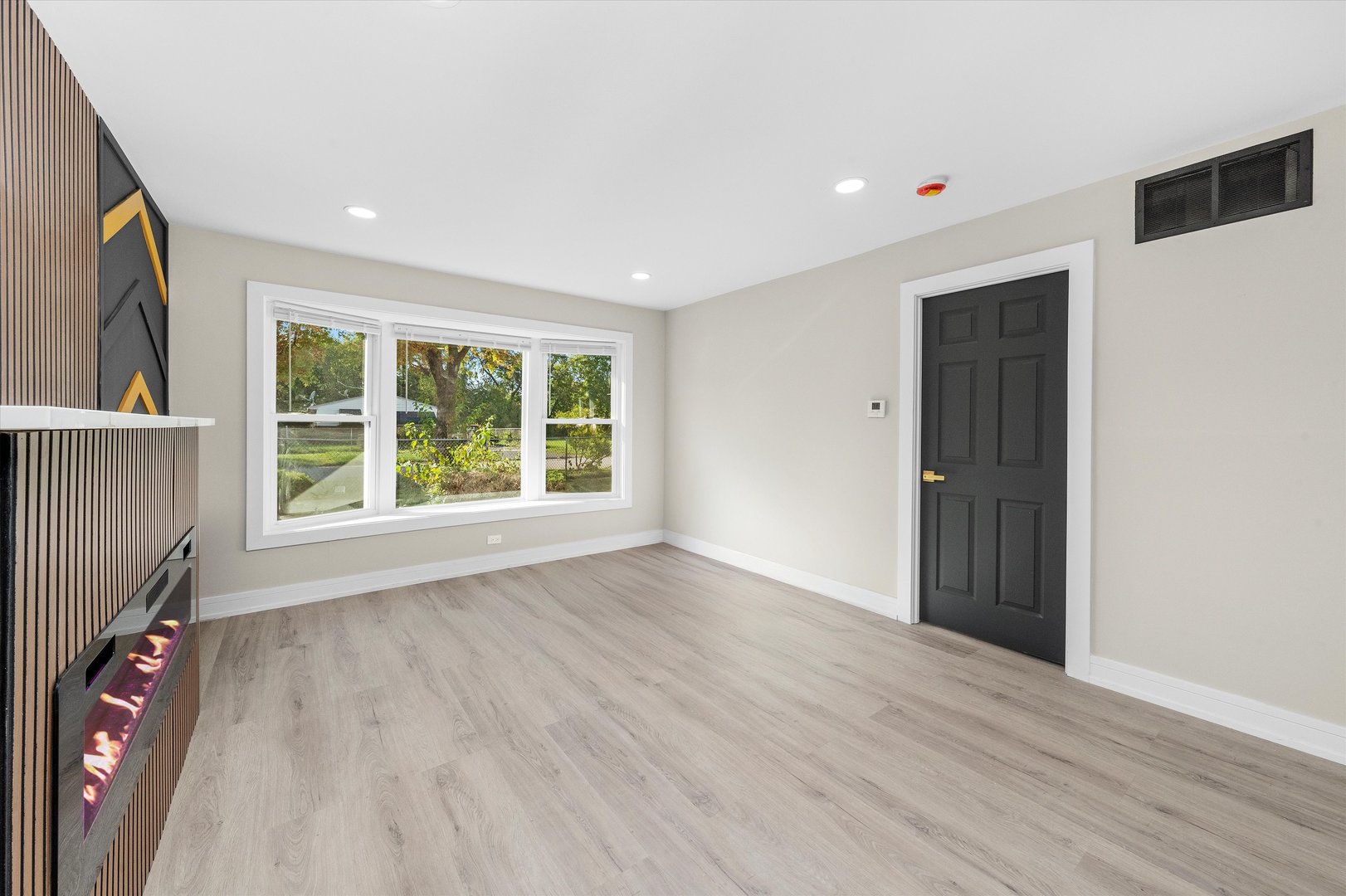 16619 Marshfield Avenue Markham, IL 60428 - Photo 6 of 41 wooden floor in an empty room with a window