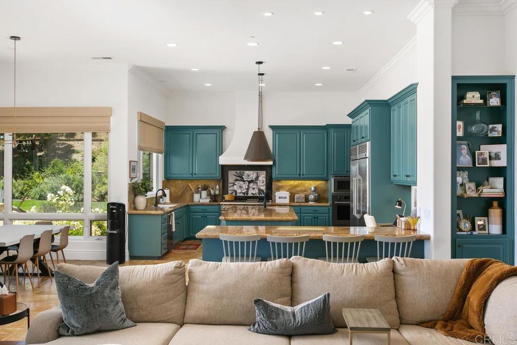 18365 Old Coach Way Poway, CA 92064 - Photo 11 of 55 a living room with furniture kitchen view and a large window