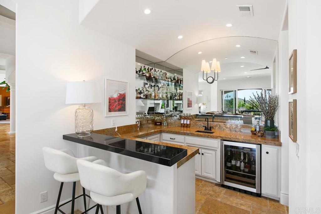 18365 Old Coach Way Poway, CA 92064 - Photo 18 of 55 a kitchen with a sink and chairs