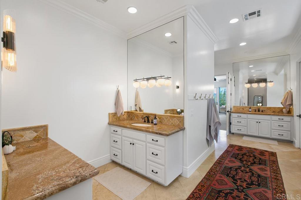 18365 Old Coach Way Poway, CA 92064 - Photo 27 of 55 a spacious bathroom with a double vanity sink and a mirror