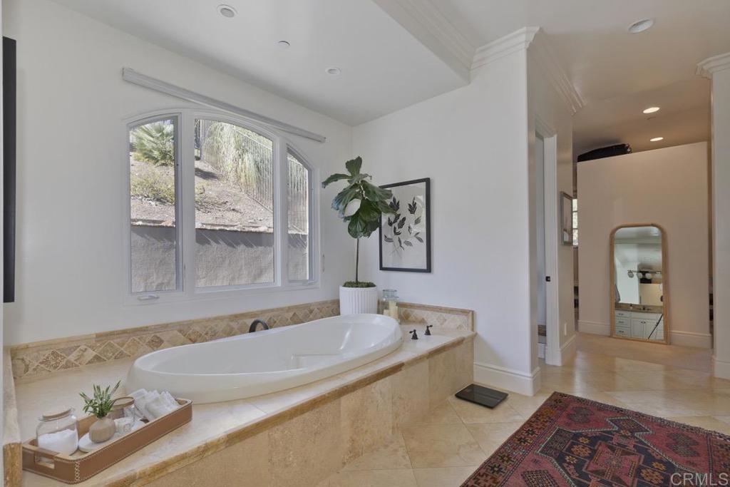 18365 Old Coach Way Poway, CA 92064 - Photo 28 of 55 a bathroom with a tub a sink and a window
