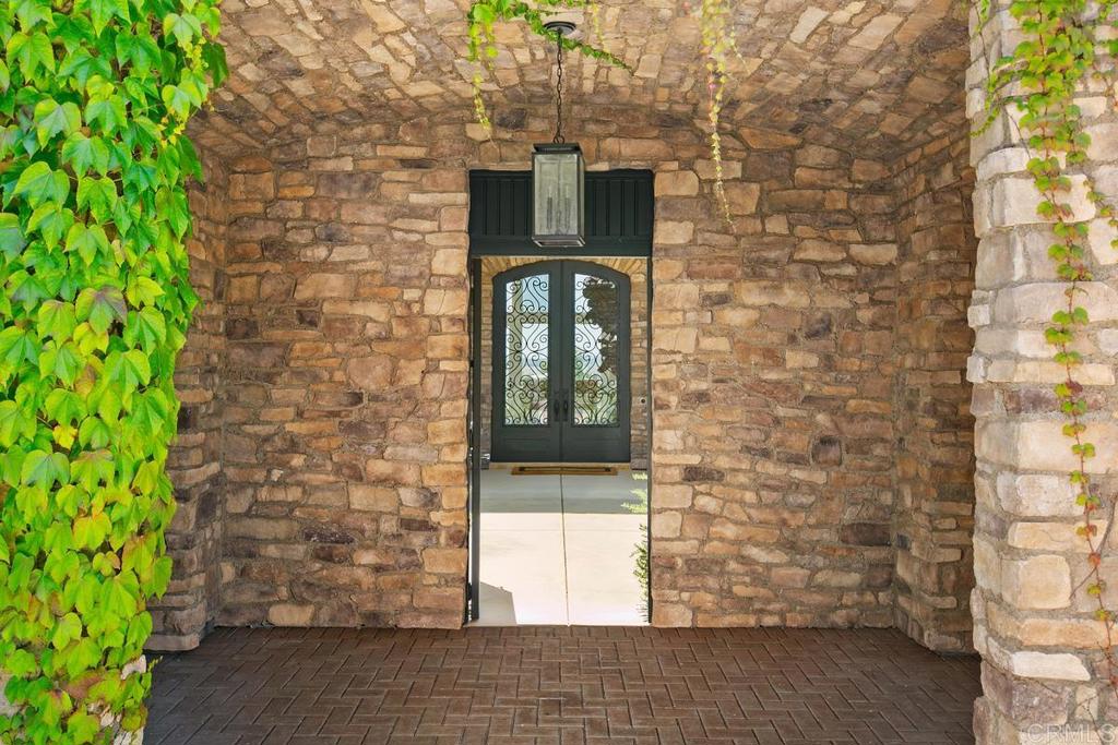 18365 Old Coach Way Poway, CA 92064 - Photo 3 of 55 a front view of a brick house with a door