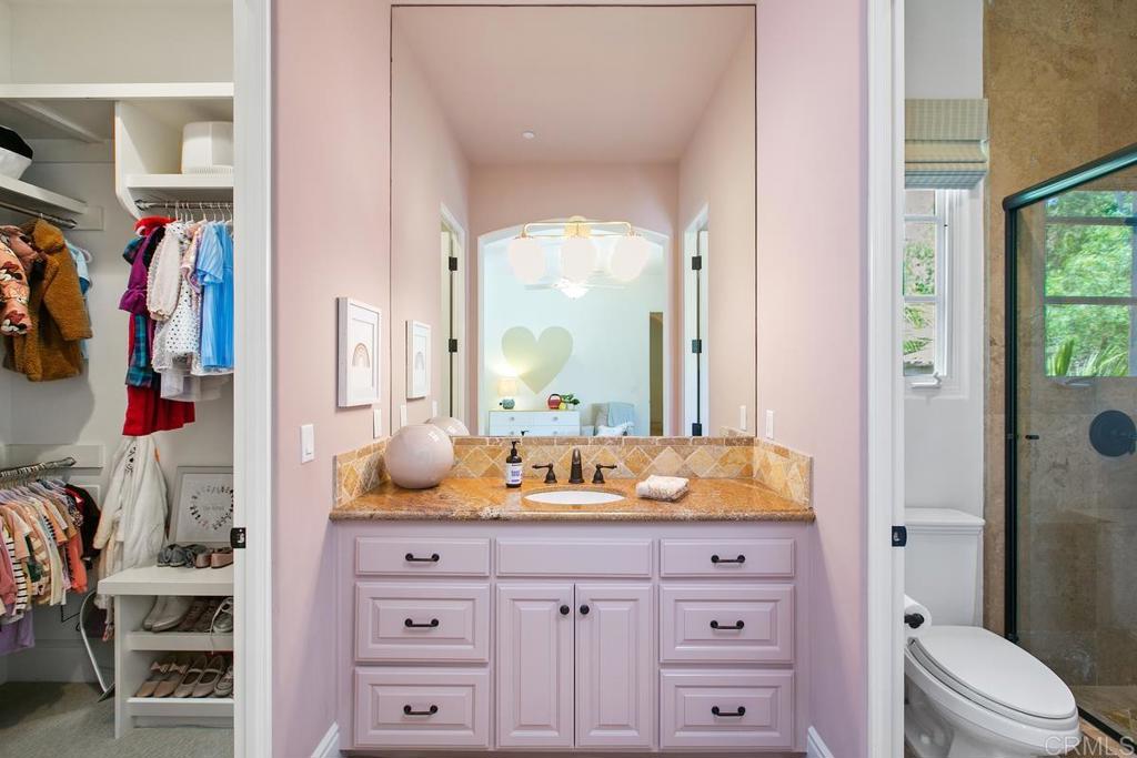 18365 Old Coach Way Poway, CA 92064 - Photo 34 of 55 a bathroom with a granite countertop sink mirror vanity and next to a window