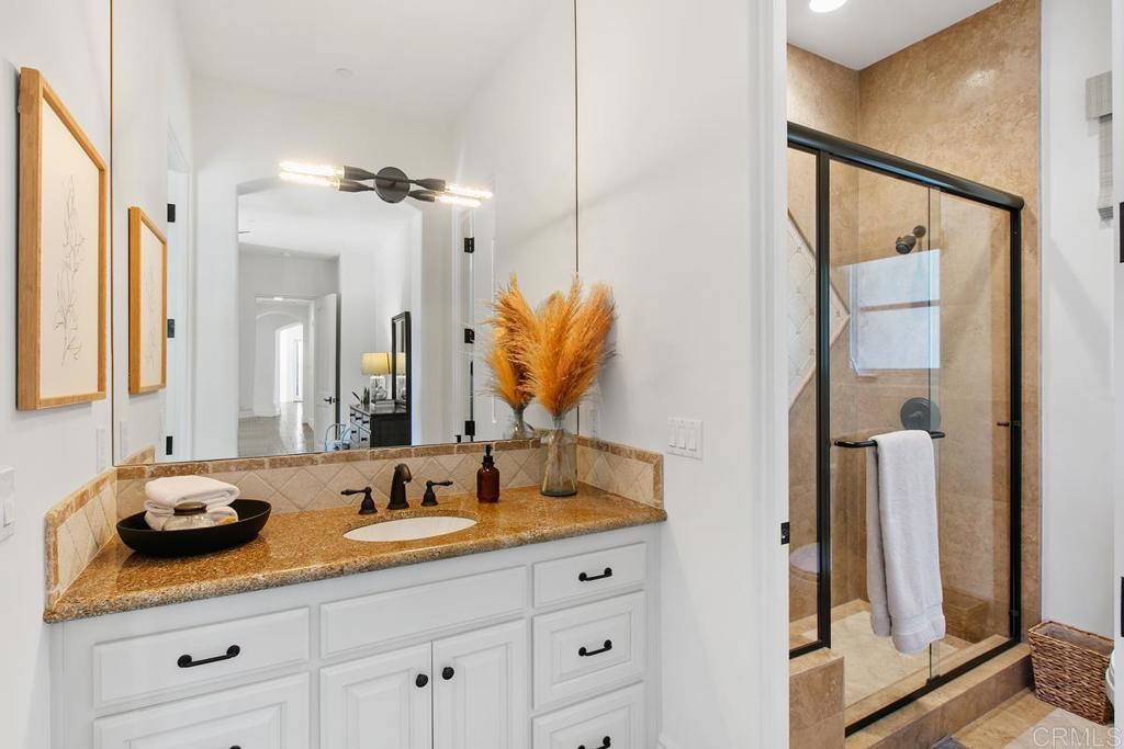 18365 Old Coach Way Poway, CA 92064 - Photo 36 of 55 a bathroom with a double vanity sink and a mirror