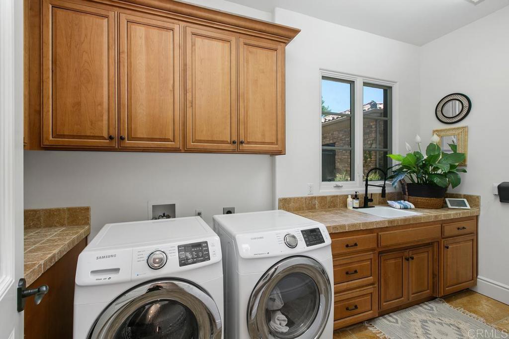 18365 Old Coach Way Poway, CA 92064 - Photo 37 of 55 a utility room with dryer and washer