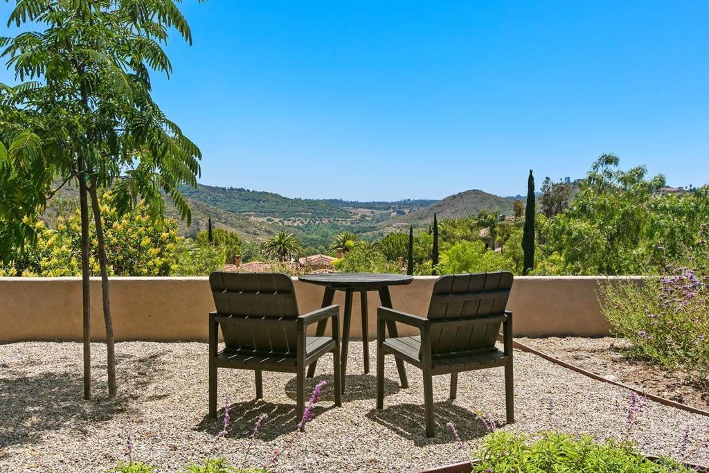 18365 Old Coach Way Poway, CA 92064 - Photo 42 of 55 a view of a chairs and table in the backyard