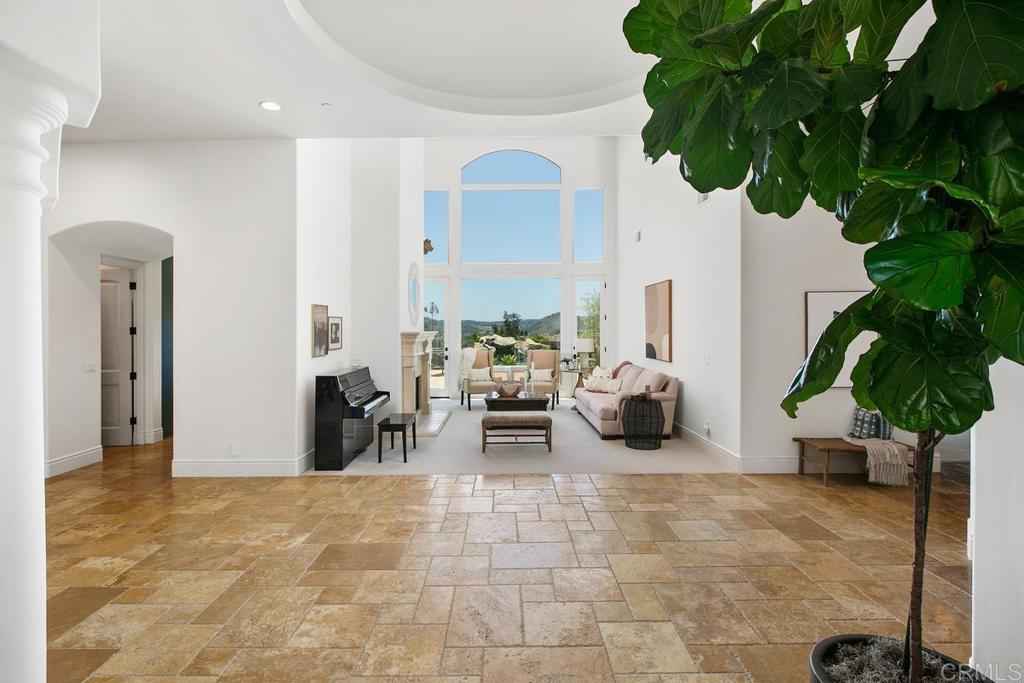 18365 Old Coach Way Poway, CA 92064 - Photo 5 of 55 a living room with furniture a potted plant and a large window