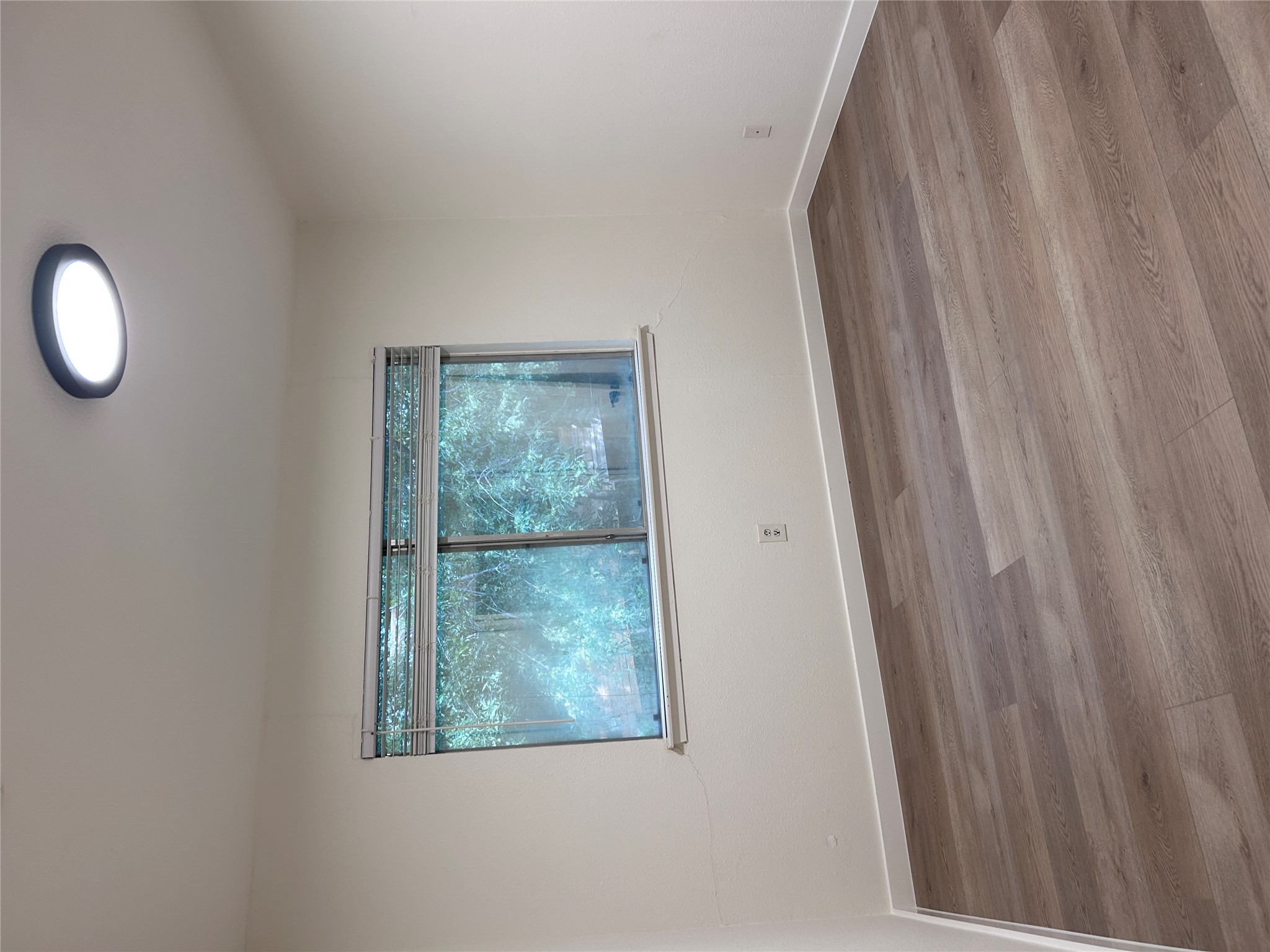 6603 Ripple Run Austin, TX 78744 - Photo 10 of 16 Newly installed wood flooring creates a clean, inviting atmosphere in this well-lit space.