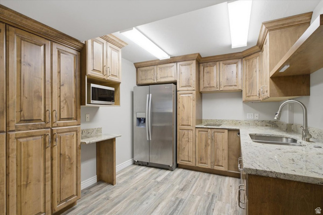 12317 Cypress Point Way Draper, UT 84020 - Photo 26 of 41 Kitchen featuring wood-finish cabinetry, stainless steel appliances, and light-toned countertops