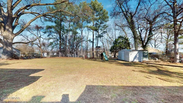 a view of yard and basketball court