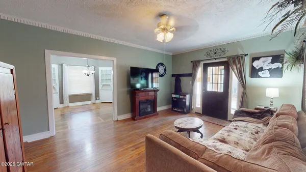a living room with furniture and a wooden floor