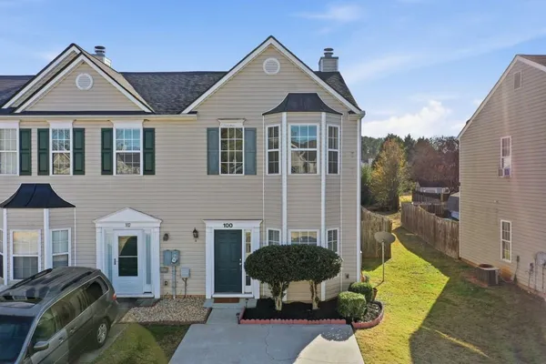 a view of a house with large windows and a yard
