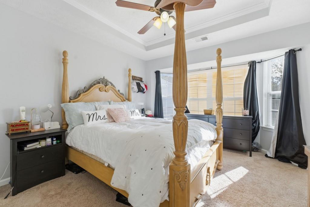 100 Benfield Circle Southeast Cartersville, GA 30121 - Photo 21 of 24 a bedroom with a bed and a chandelier