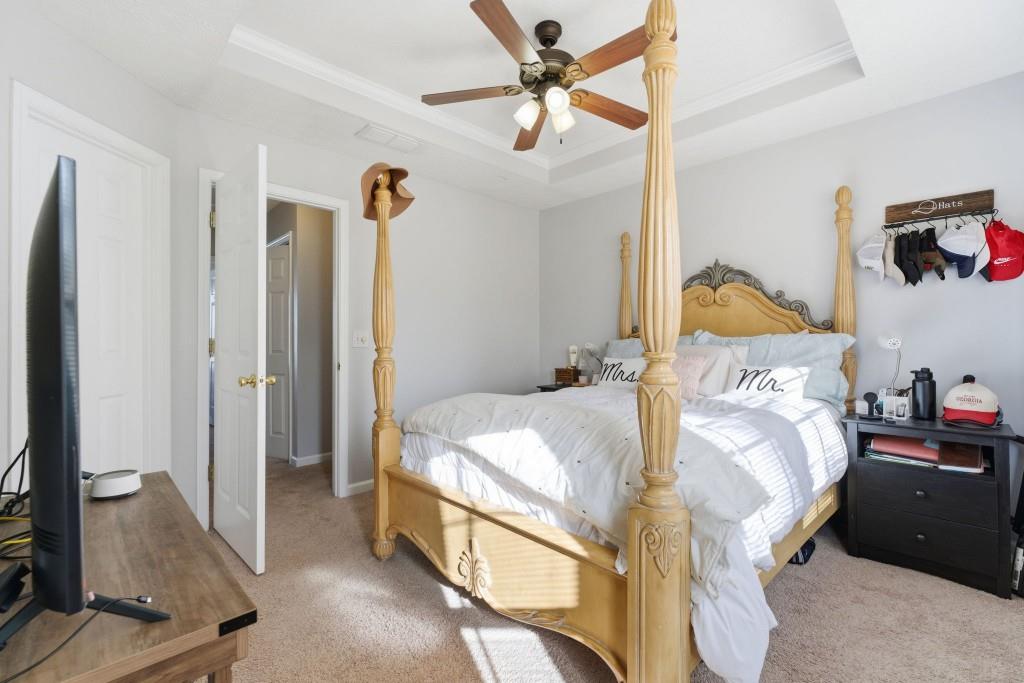 100 Benfield Circle Southeast Cartersville, GA 30121 - Photo 22 of 24 a bedroom with a bed and a chandelier