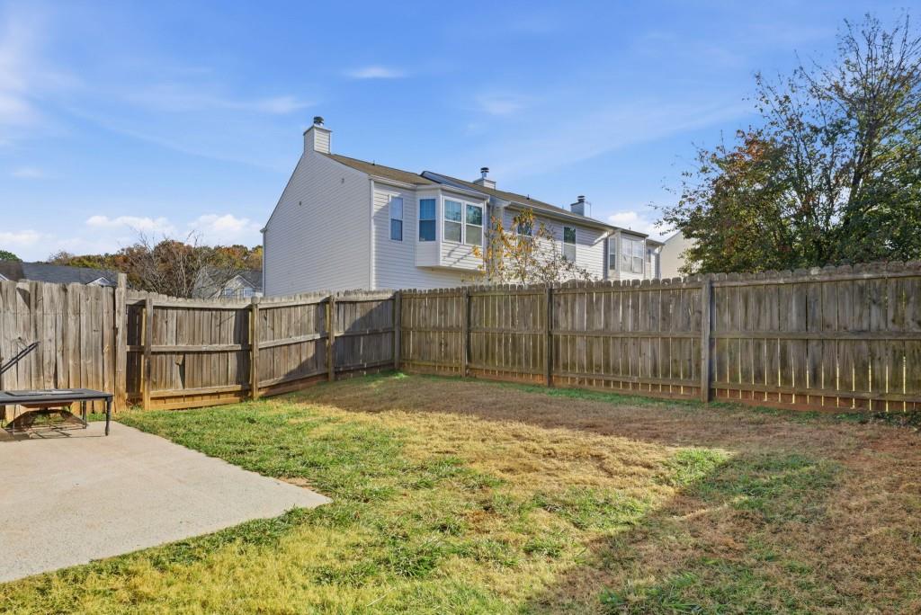 100 Benfield Circle Southeast Cartersville, GA 30121 - Photo 24 of 24 a backyard of a house with large trees and wooden fence