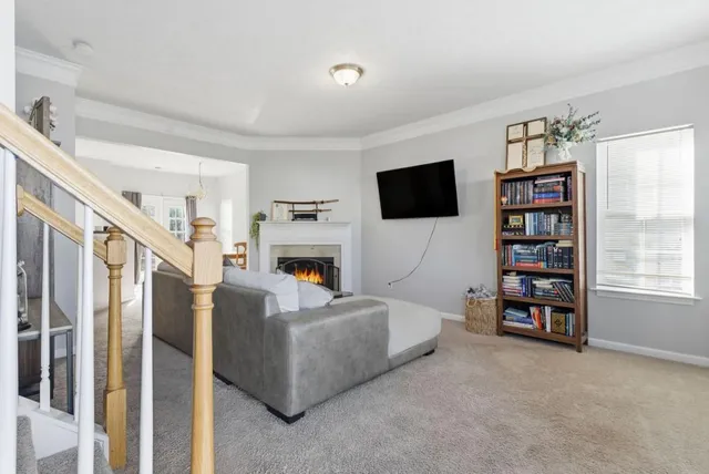 a living room with fireplace furniture and a flat screen tv