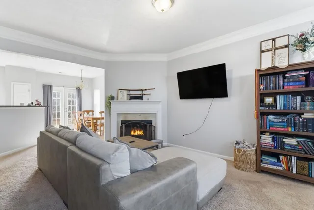 a living room with a flat screen tv and a fireplace