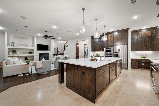 a living room with furniture and a kitchen area