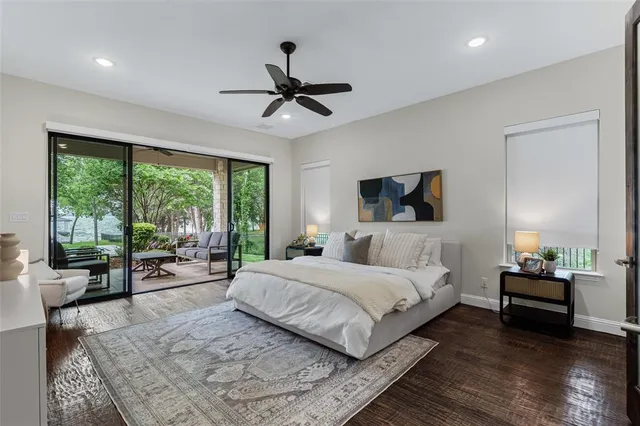 a bedroom with a large bed and a chandelier