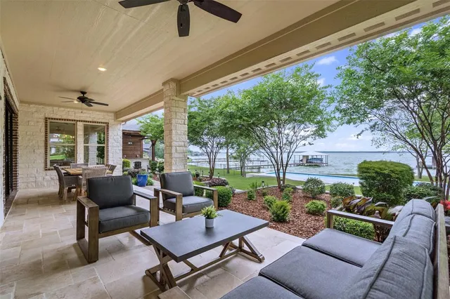 a view of a patio with a table chairs and a backyard