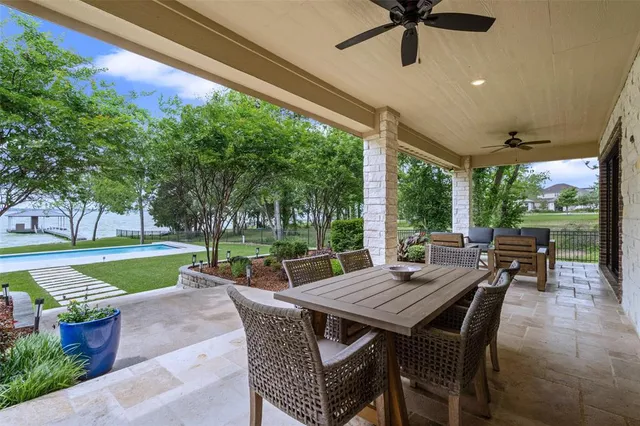 a view of a patio with a table chairs and a backyard