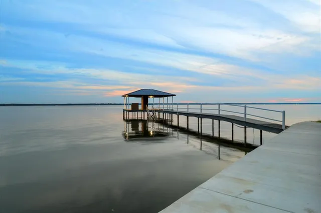 an aerial view of a house with a swimming pool and outdoor seating