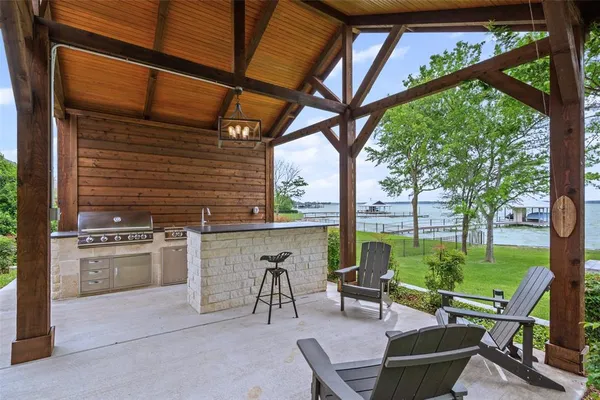 a view of a patio with a table chairs and a backyard