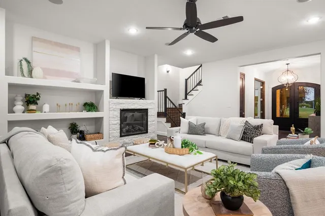 a living room with furniture a fireplace and a flat screen tv