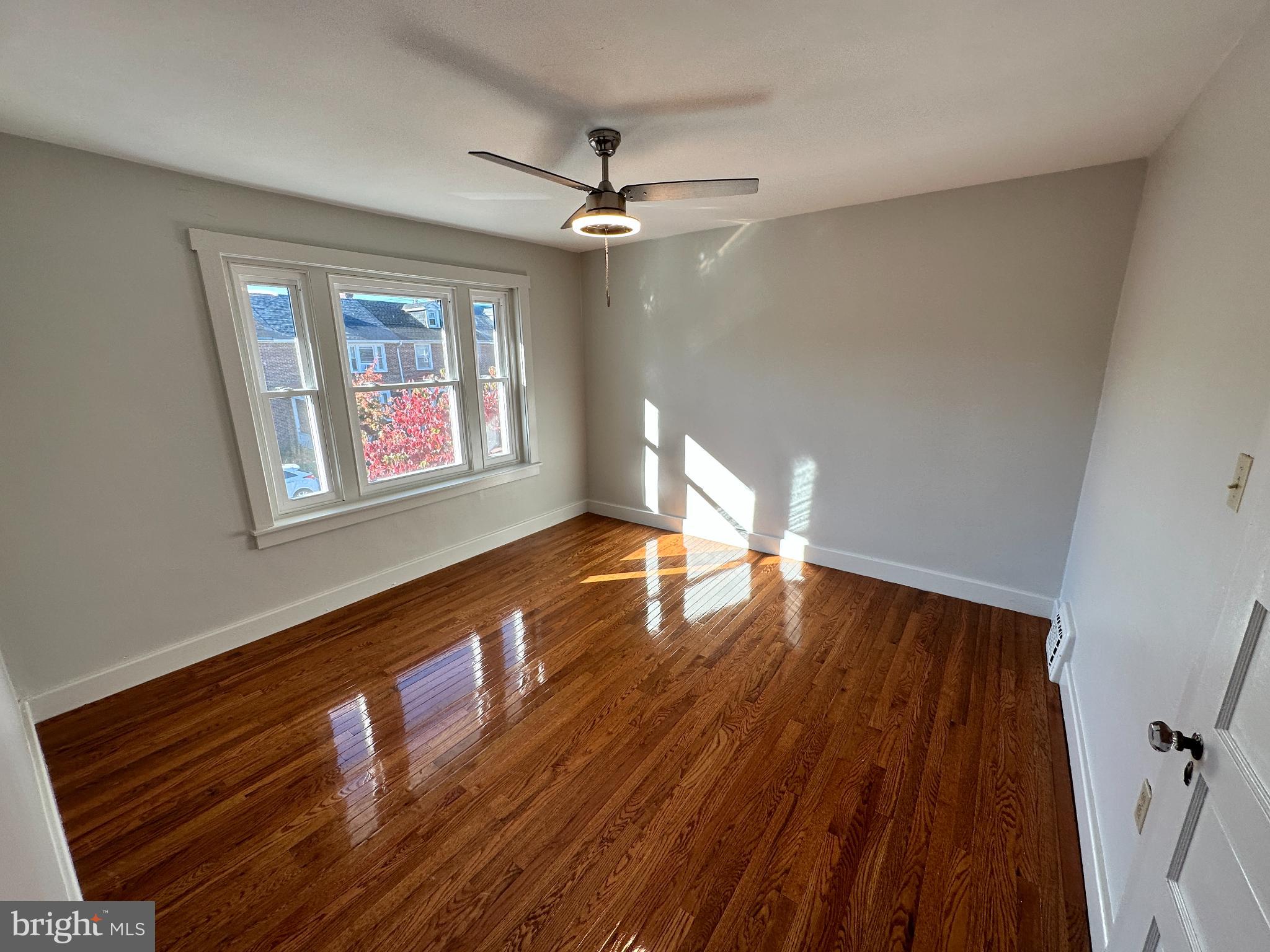 389 Oak Terrace Reading, PA 19611 - Photo 11 of 15 a view of an empty room with wooden floor and a window