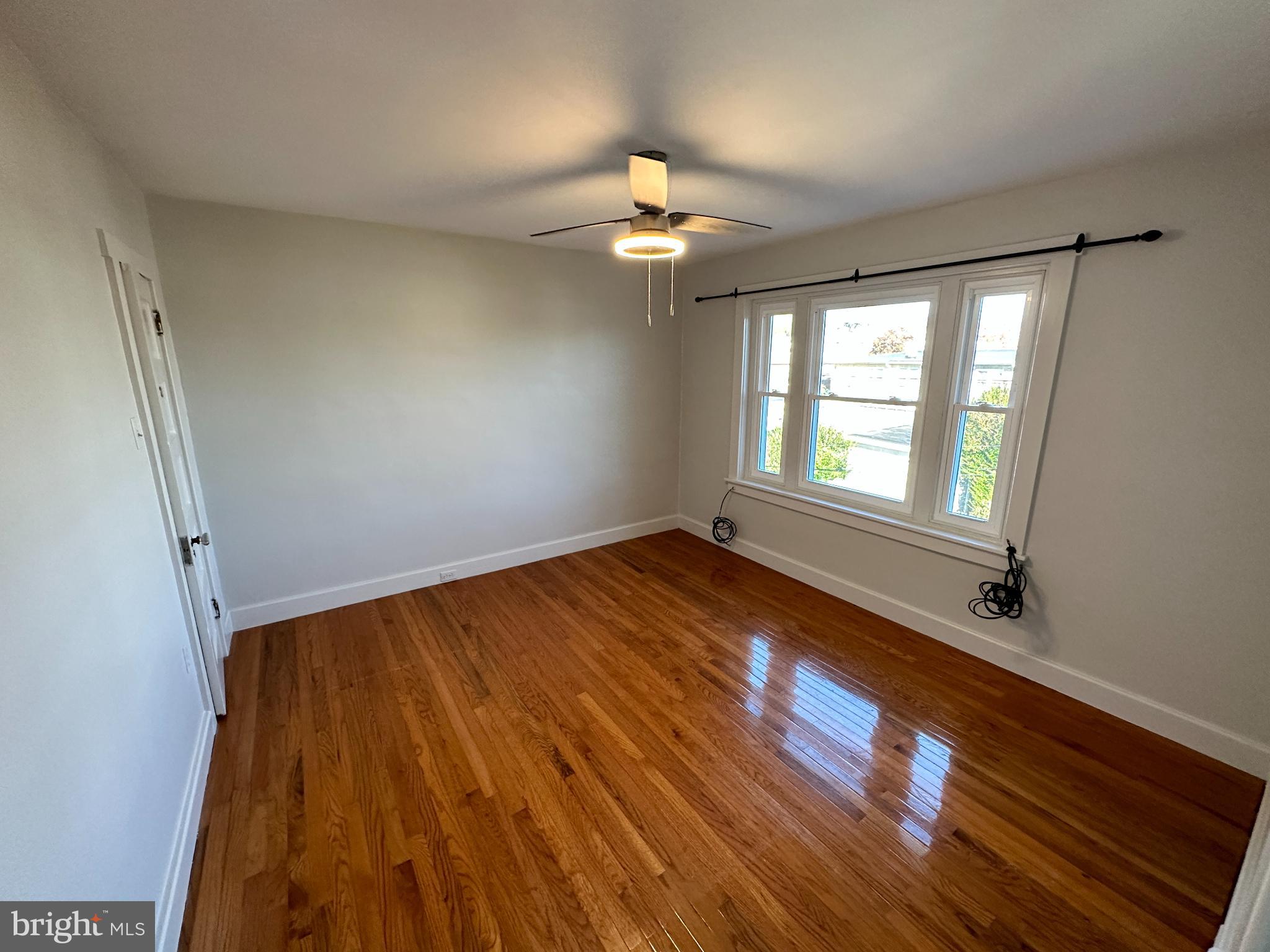 389 Oak Terrace Reading, PA 19611 - Photo 9 of 15 a view of empty room with wooden floor and fan