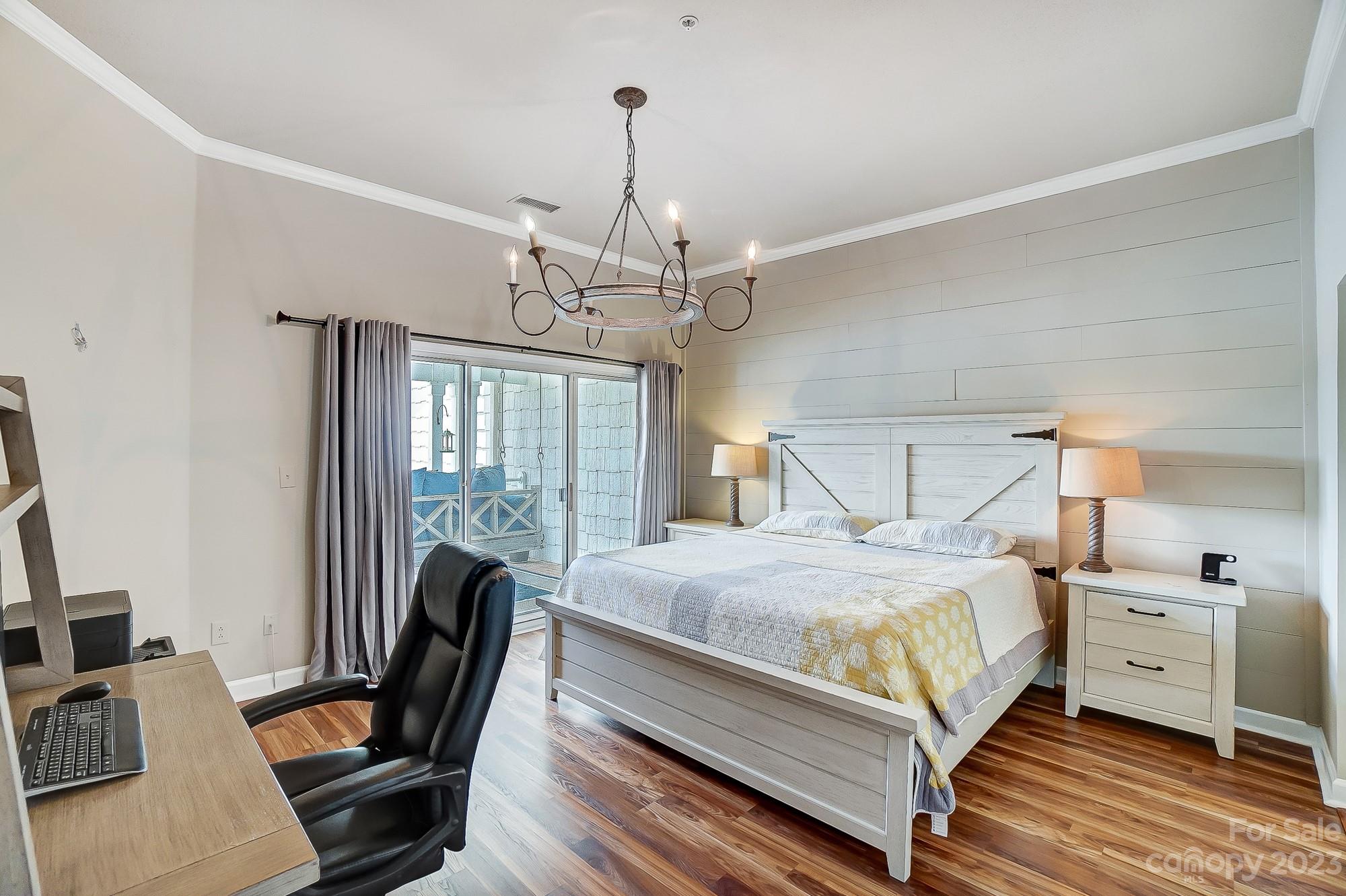 1230 Torrence Circle Davidson, NC 28036 - Photo 12 of 23 a bedroom with a bed wooden floor and a table chair