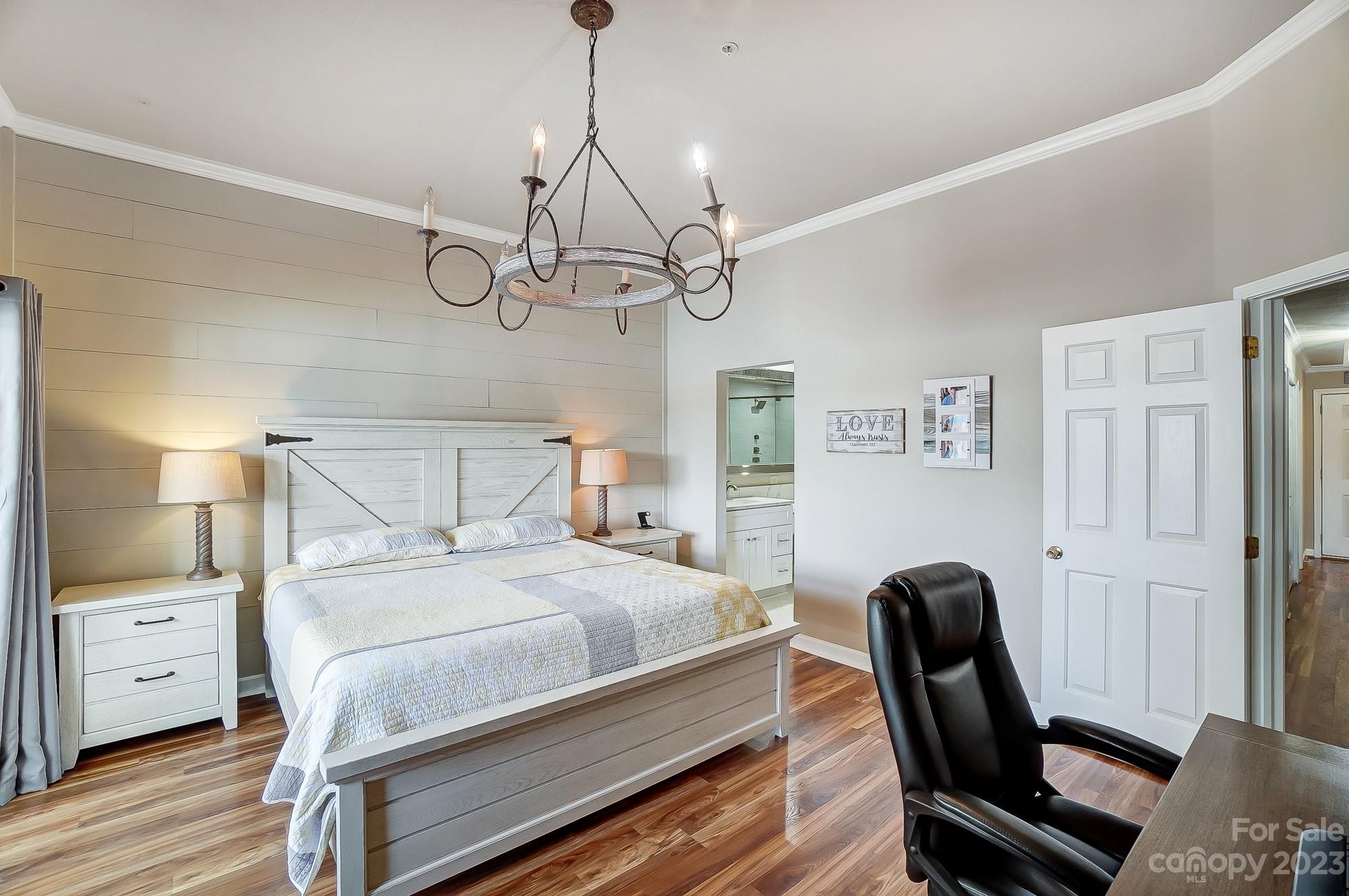 1230 Torrence Circle Davidson, NC 28036 - Photo 13 of 23 a bedroom with a bed and a chandelier
