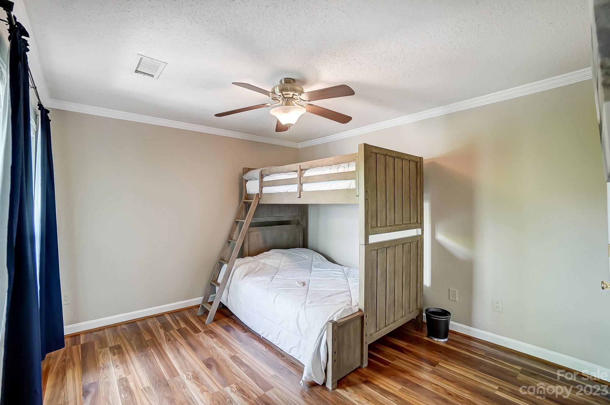 1230 Torrence Circle Davidson, NC 28036 - Photo 17 of 23 a bedroom with a bed and a ceiling fan