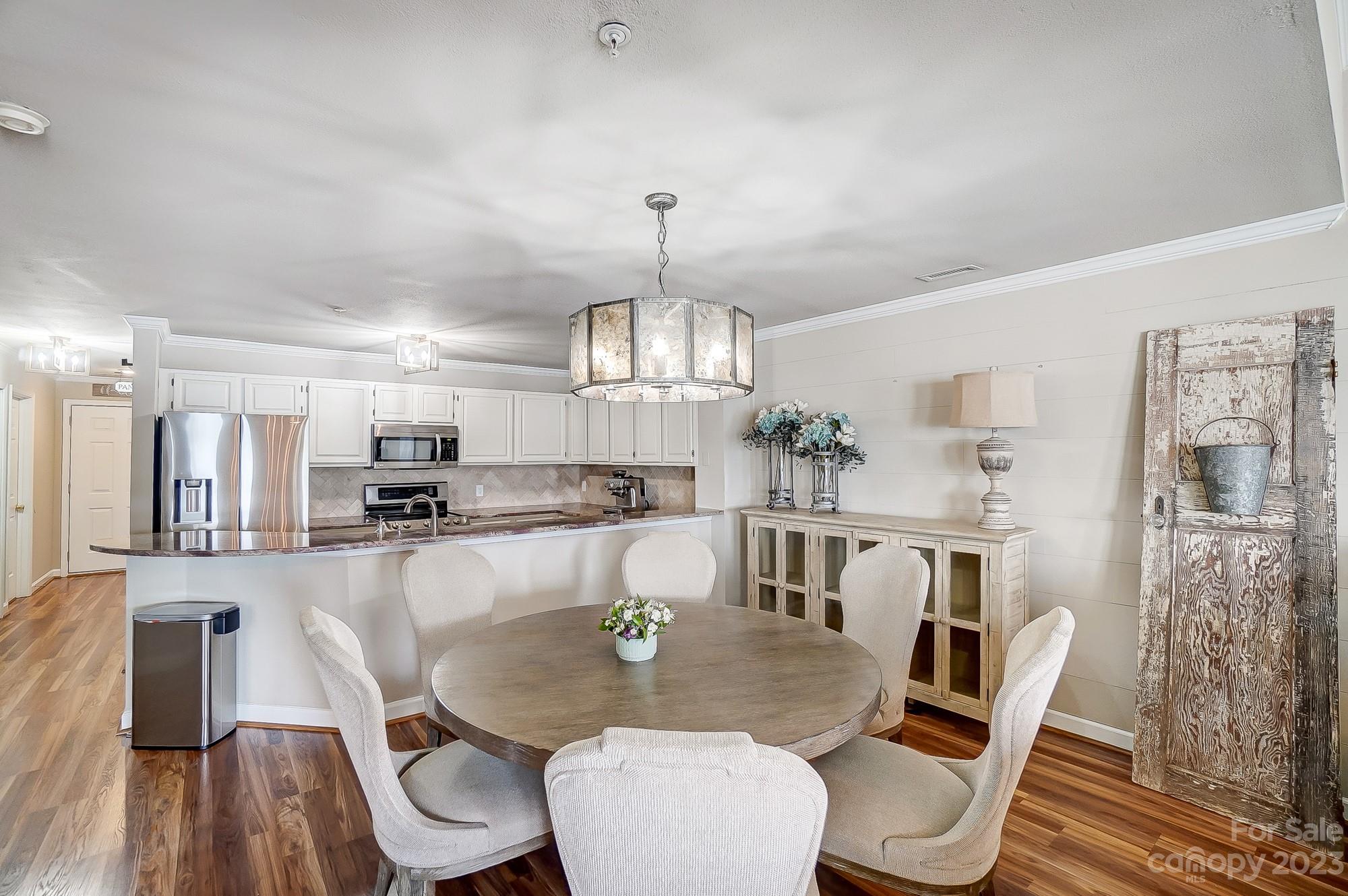 1230 Torrence Circle Davidson, NC 28036 - Photo 9 of 23 a large kitchen with a table and chairs