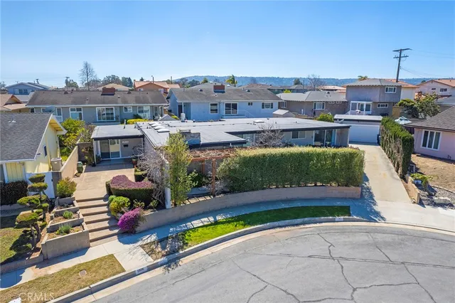an aerial view of a house with a yard basket ball court and outdoor seating