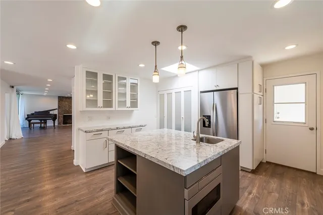a kitchen with a sink stove and refrigerator