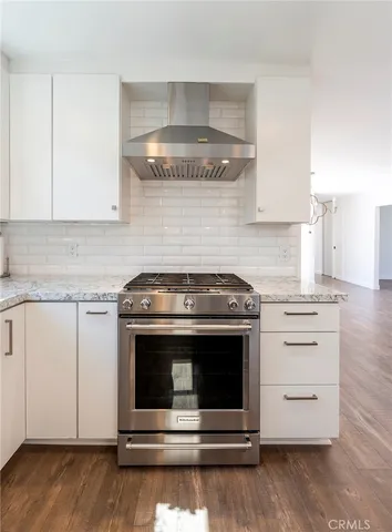 a kitchen with granite countertop counter top space a sink stainless steel appliances and cabinets