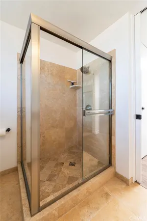 a bathroom with a granite countertop sink a toilet and shower