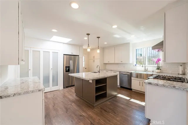 a kitchen with a sink stove and refrigerator