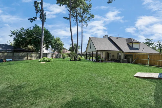 a front view of a house with a garden and trees