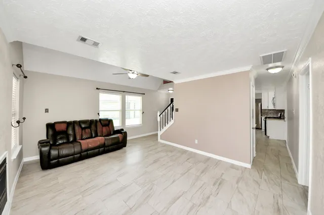 a kitchen that has a lot of cabinets in it and wooden floors