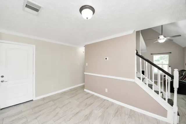 a kitchen with granite countertop white cabinets and stainless steel appliances