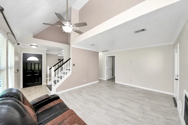 a large kitchen with stainless steel appliances granite countertop a lot of counter space and wooden floors