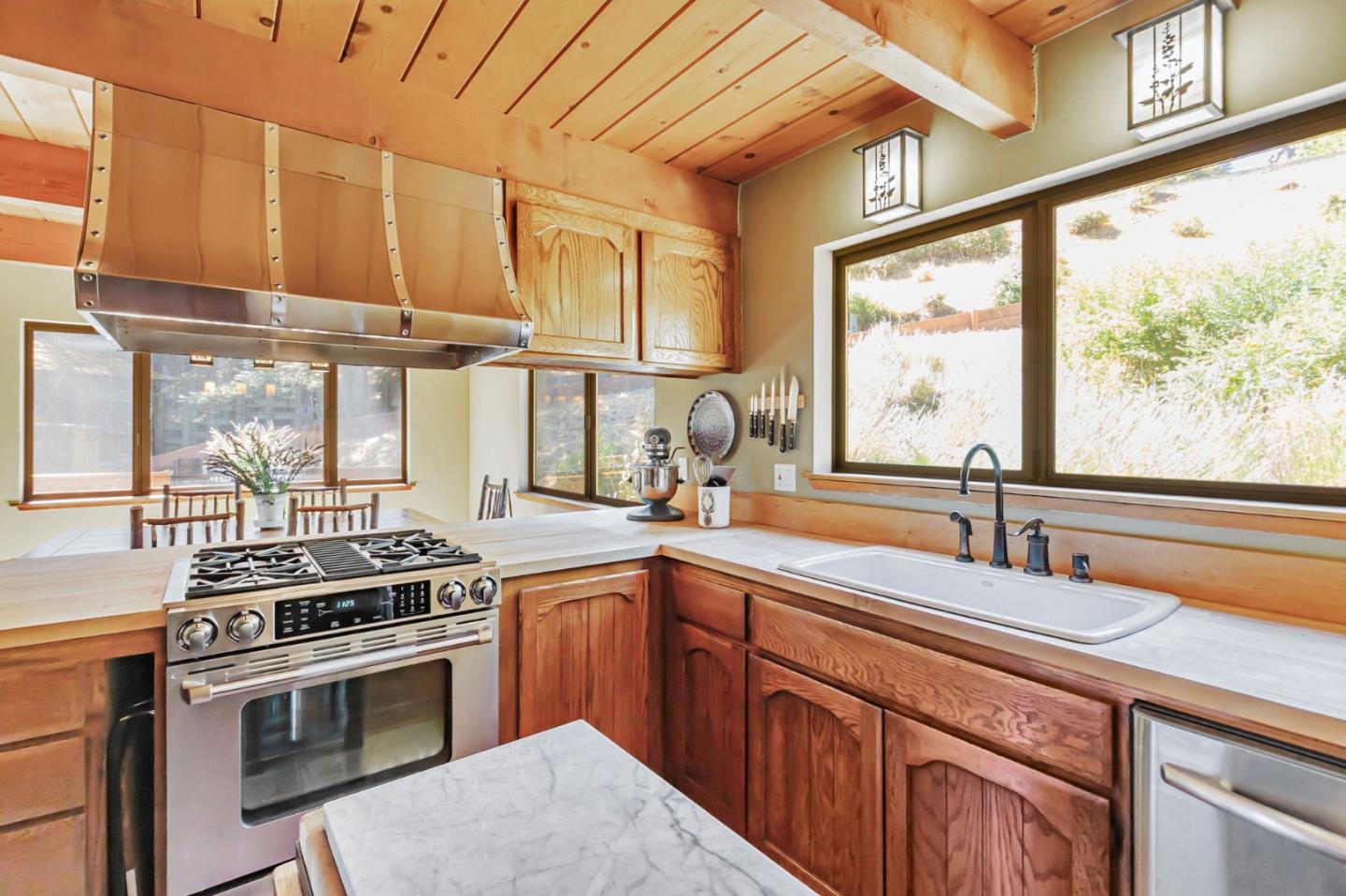 855 Oak Ridge Road Los Gatos, CA 95033 - Photo 19 of 73 a kitchen with stainless steel appliances a sink a stove and a window
