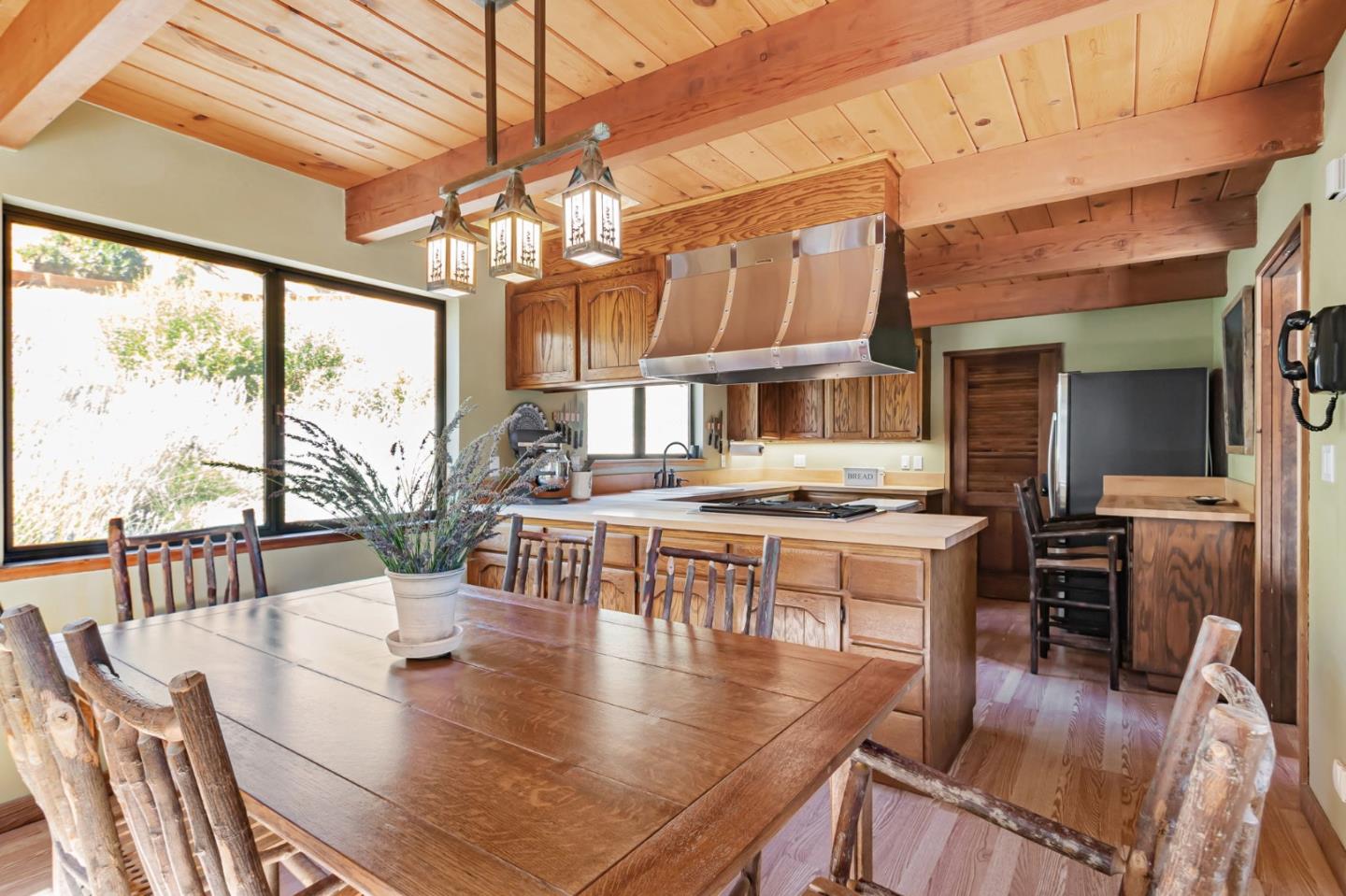 855 Oak Ridge Road Los Gatos, CA 95033 - Photo 22 of 73 a dining room with wooden floor a chandelier a glass table and chairs