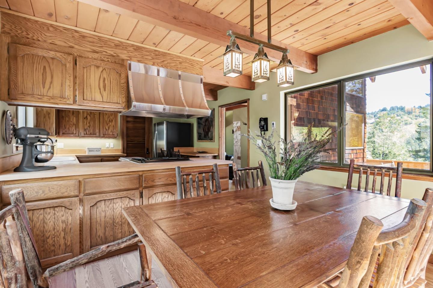 855 Oak Ridge Road Los Gatos, CA 95033 - Photo 23 of 73 a kitchen with stainless steel appliances granite countertop a refrigerator a stove top oven a dining table and chairs with wooden floor