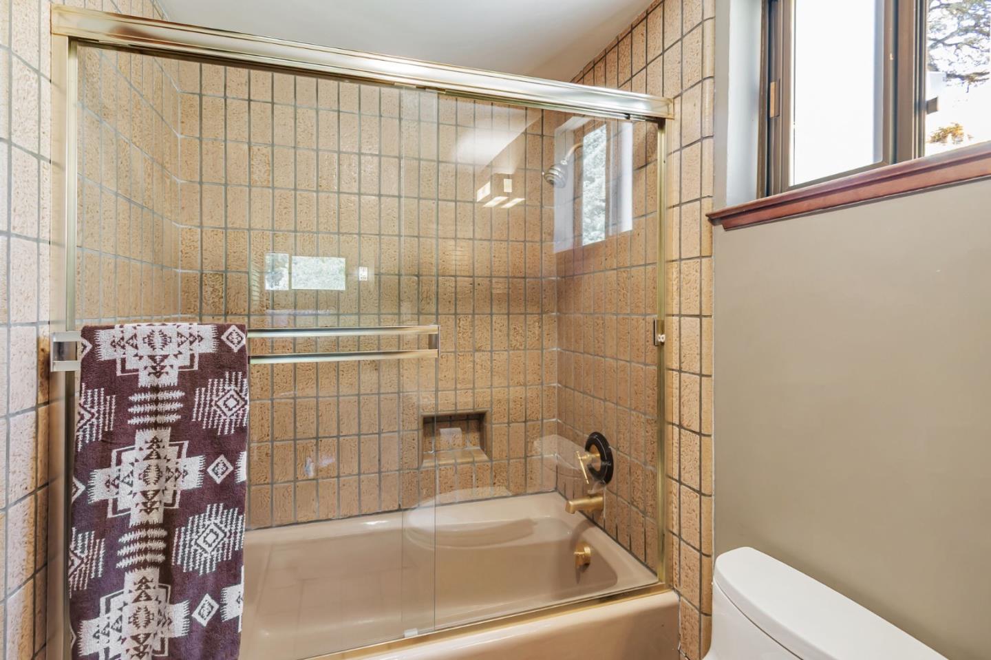 855 Oak Ridge Road Los Gatos, CA 95033 - Photo 42 of 73 a bathroom with a bathtub and shower