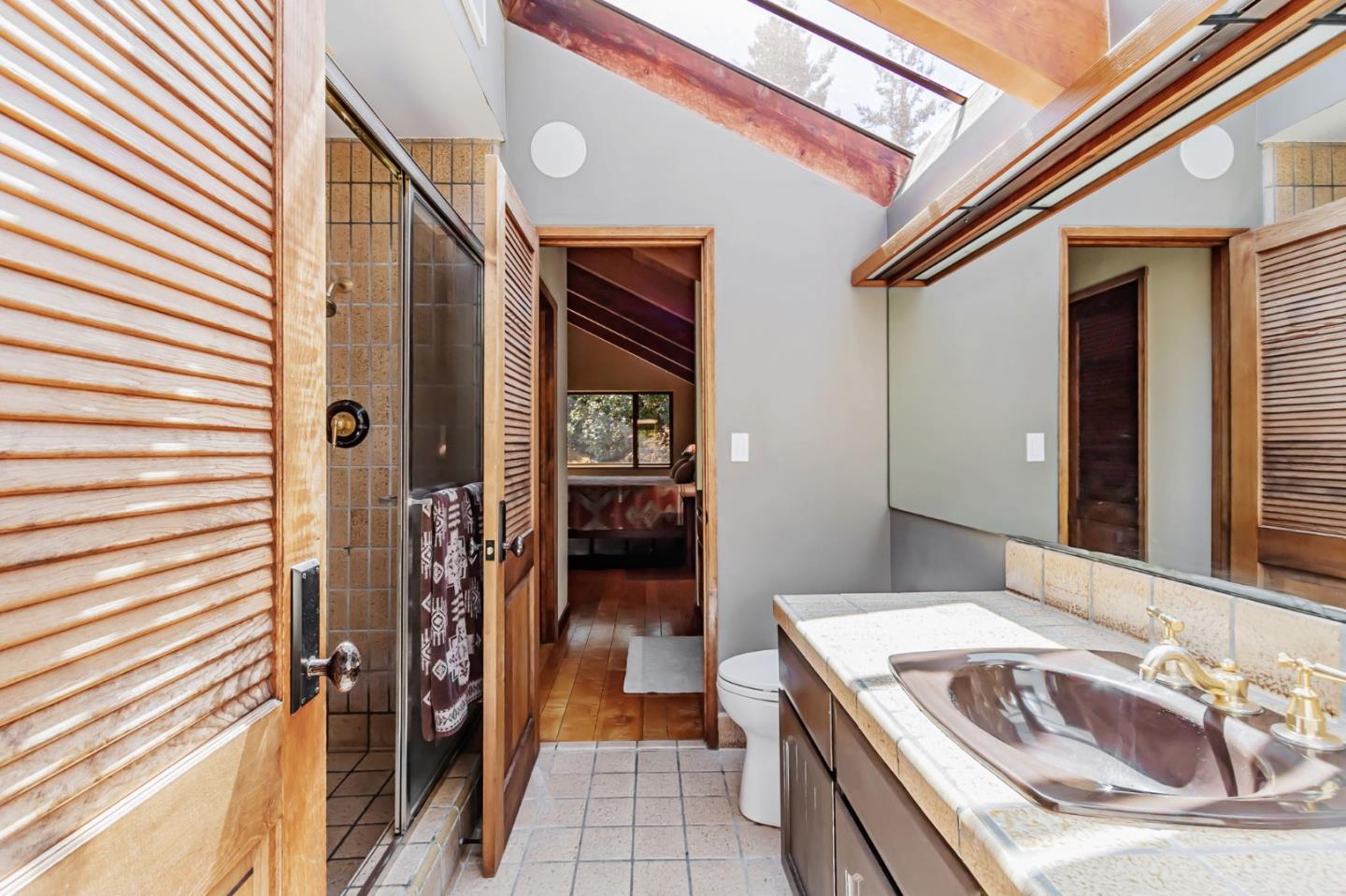 855 Oak Ridge Road Los Gatos, CA 95033 - Photo 46 of 73 a en suite bathroom with a granite countertop sink and a mirror