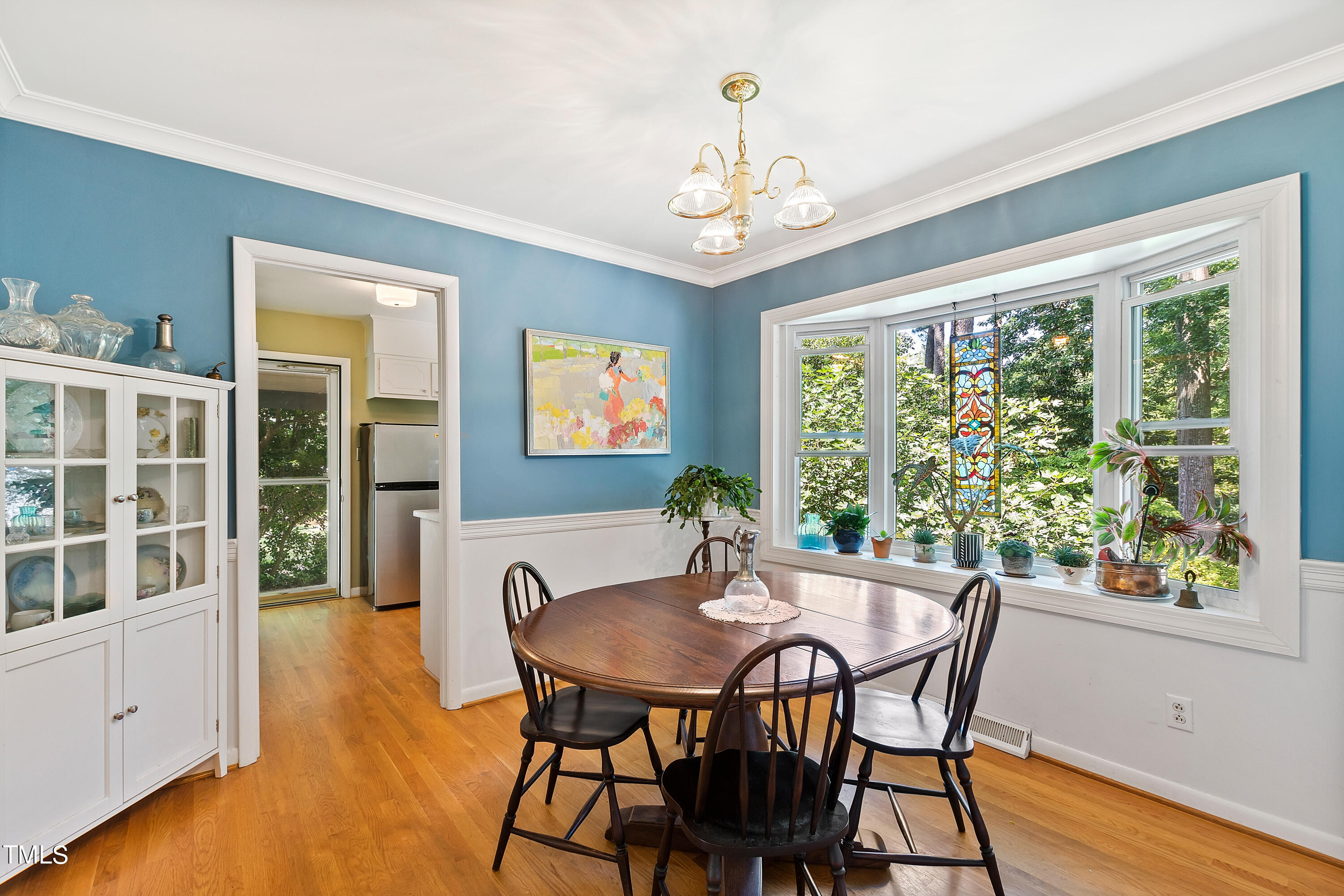 4832 Latimer Road Raleigh, NC 27609 - Photo 15 of 47 a view of a dining room with furniture window and wooden floor